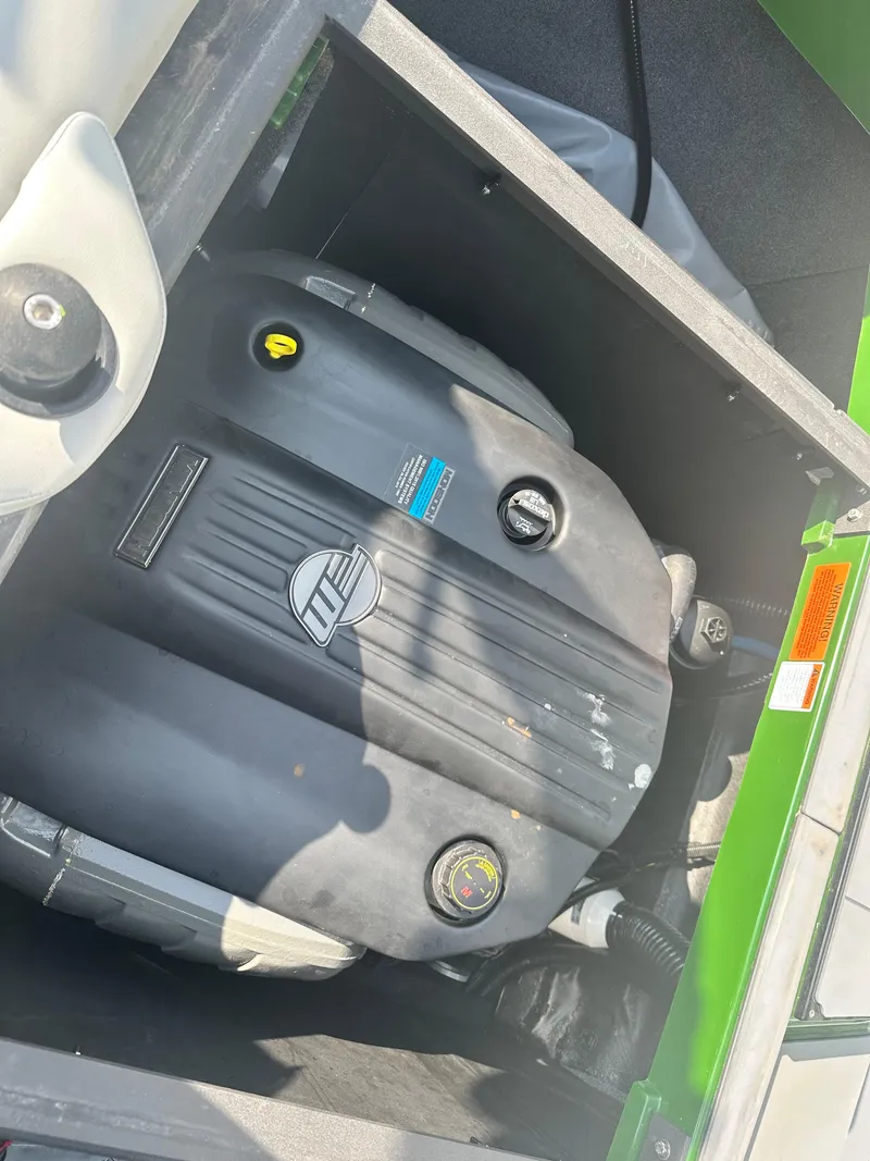 Slide: The Image of 2022 Axis A22 engine compartment with visible components and green exterior. - 16