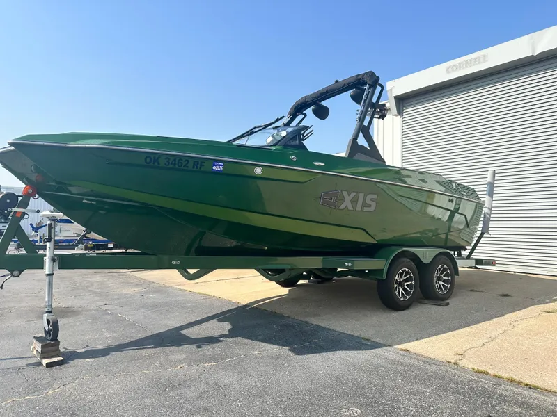 Slide: The Image of 2022 Axis A22 green boat on trailer near garage. - 3