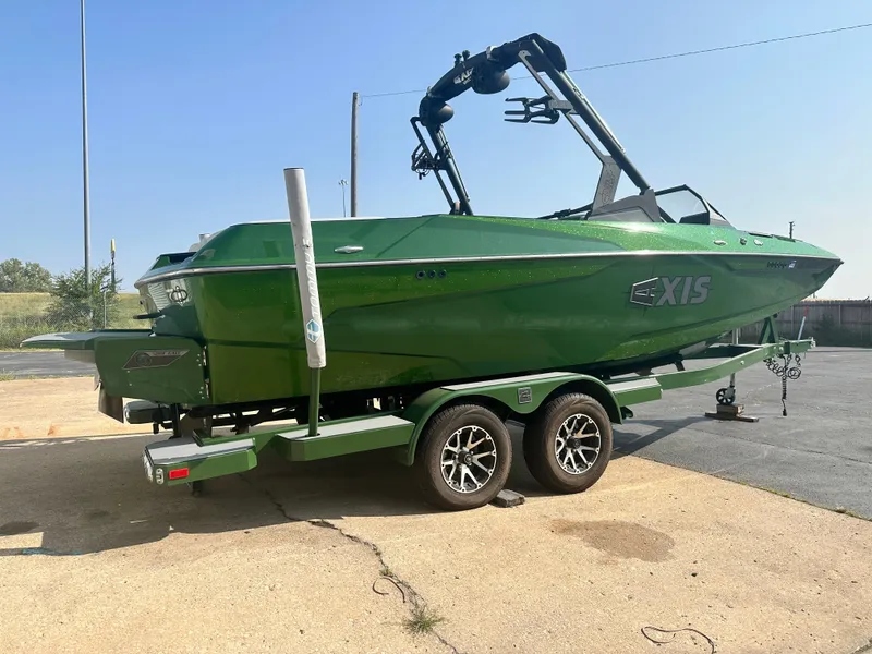 Slide: The Image of Green 2022 Axis A22 boat on trailer, parked outdoors. - 4