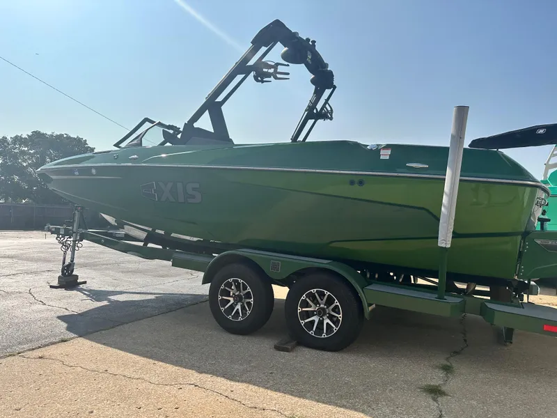 Slide: The Image of Green 2022 Axis A22 boat on trailer in sunny outdoor setting. - 6
