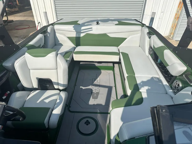 Slide: The Image of 2022 Axis A22 boat interior with green and white seating, spacious layout. - 8