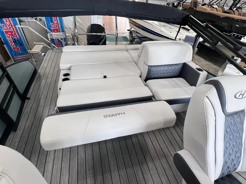 Slide: The Image of 2024 Harris Sunliner 230 boat interior with luxurious white seating and gray accents. - 10