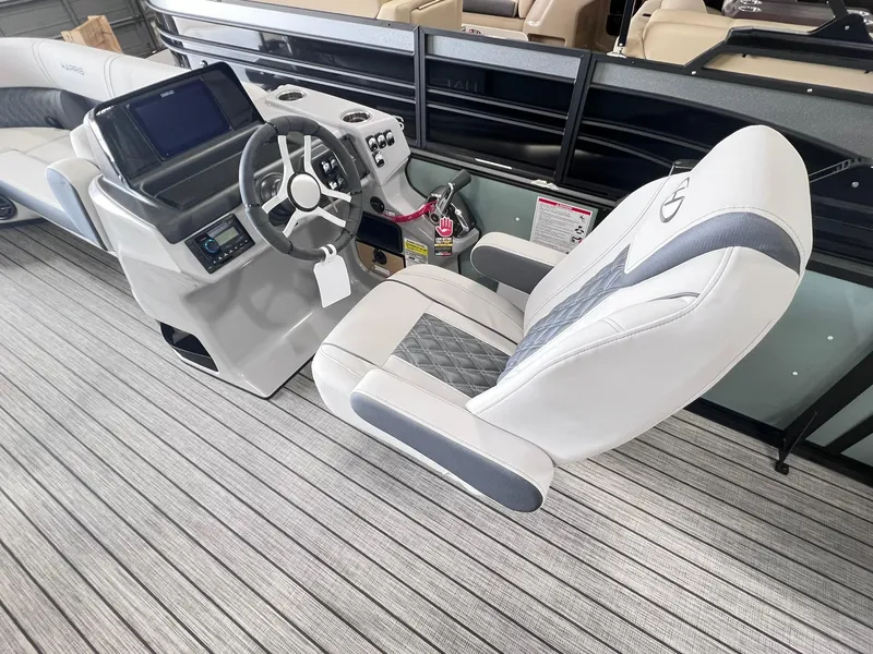 Slide: The Image of 2024 Harris Sunliner 230 boat interior with modern helm and plush seating. - 12