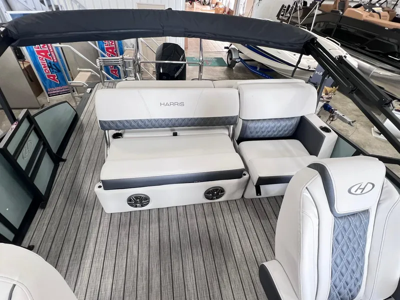 Slide: The Image of 2024 Harris Sunliner 230 boat interior with plush seating and modern design. - 8