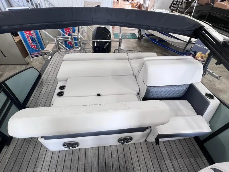 Slide: The Image of 2024 Harris Sunliner 230 boat interior with plush seating and modern design. - 9