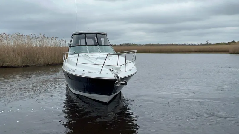 Slide: The Image of 2020 Monterey 345 SY boat on calm water with cloudy sky backdrop. - 12