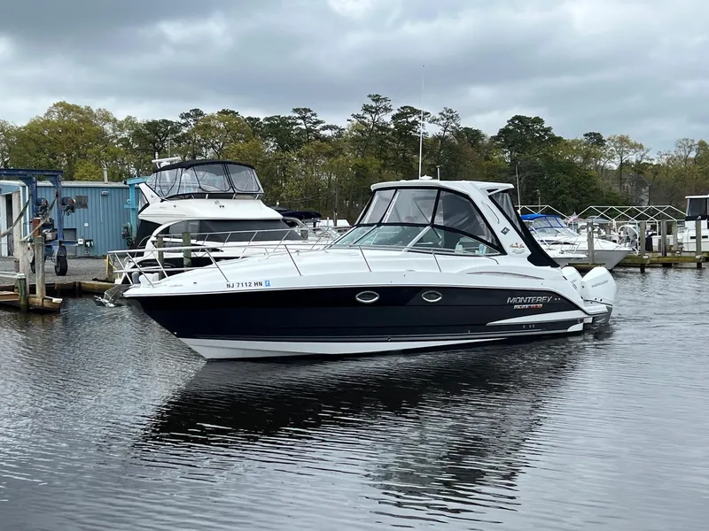 Slide: The Image of 2020 Monterey 345 SY boat docked in a marina, overcast sky. - 15