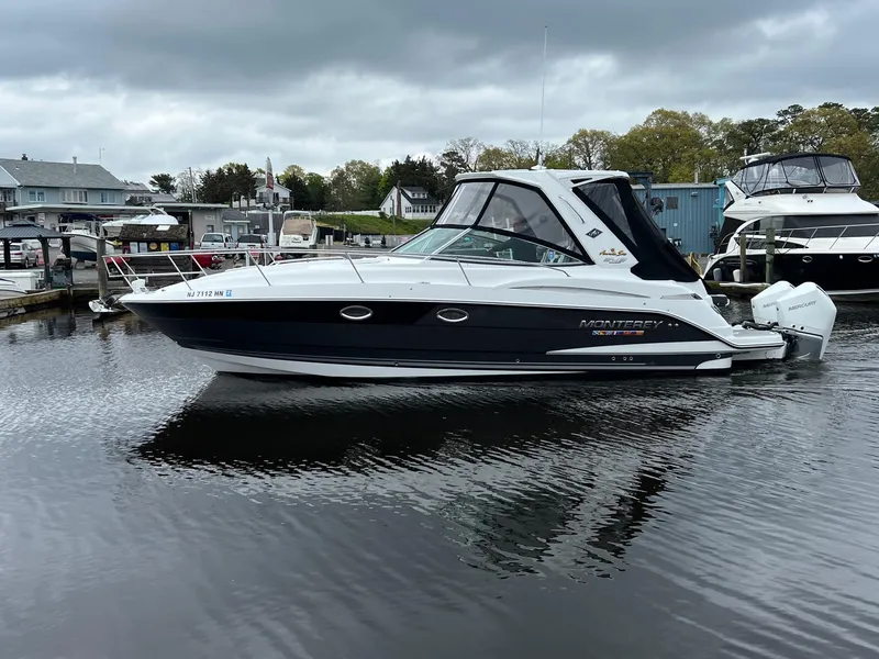 Slide: The Image of 2020 Monterey 345 SY boat docked in a marina under cloudy skies. - 16