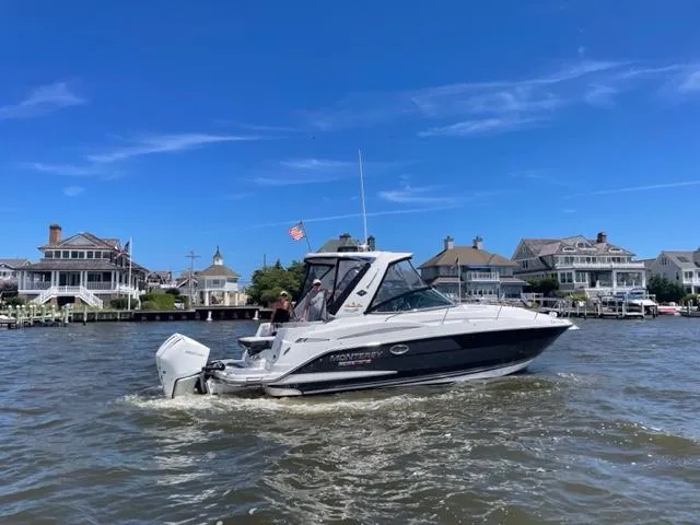 Slide: The Image of 2020 Monterey 345 SY boat cruising near waterfront homes under a clear blue sky. - 17