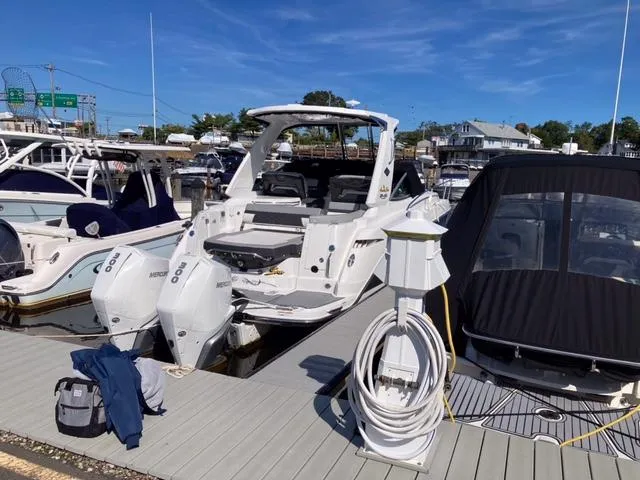 Slide: The Image of 2020 Monterey 345 SY boat docked at marina with twin outboard engines. - 18