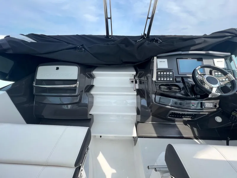 Slide: The Image of Monterey 345 SY 2020 boat cockpit with modern controls and steering wheel. - 22