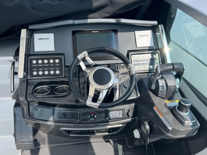 Slide: The Image of 2020 Monterey 345 SY boat dashboard with steering wheel and control panel. - 26