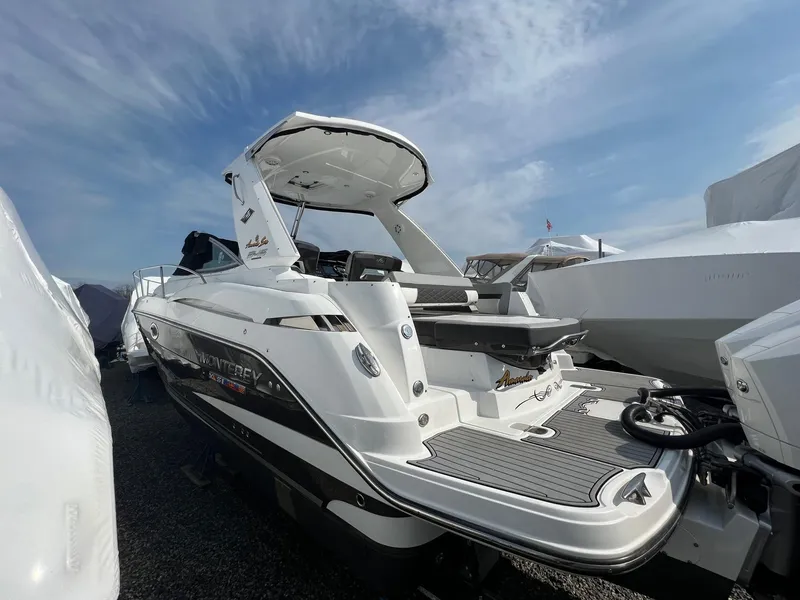 Slide: The Image of 2020 Monterey 345 SY boat with sleek design, docked under a clear sky. - 37
