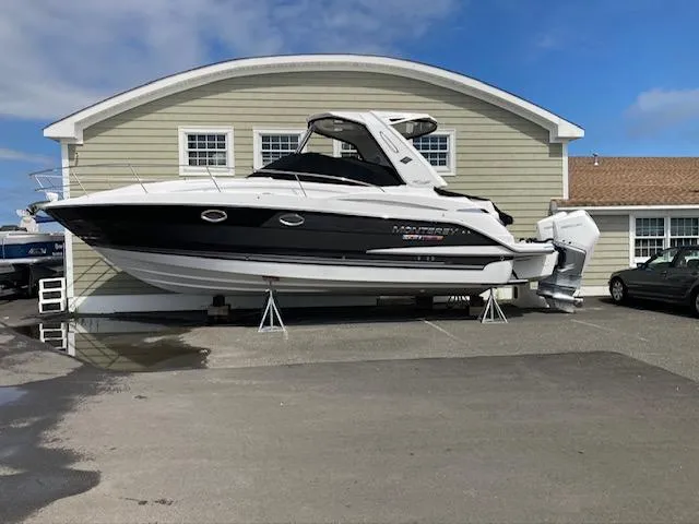 Slide: The Image of 2020 Monterey 345 SY boat displayed on stands outside a building. - 41