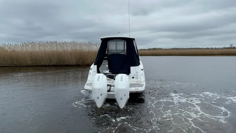 Slide: The Image of 2020 Monterey 345 SY boat with dual engines on a calm waterway. - 6