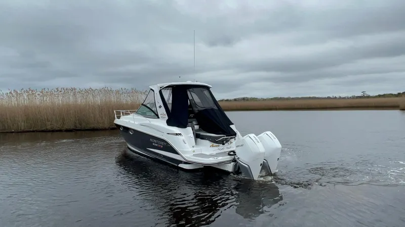 Slide: The Image of 2020 Monterey 345 SY boat cruising on a calm lake under cloudy skies. - 7