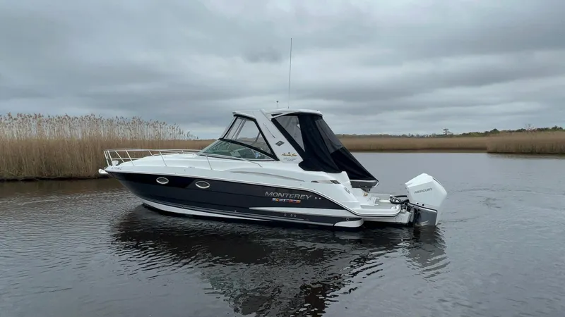 Slide: The Image of 2020 Monterey 345 SY boat on a calm lake under cloudy skies. - 9