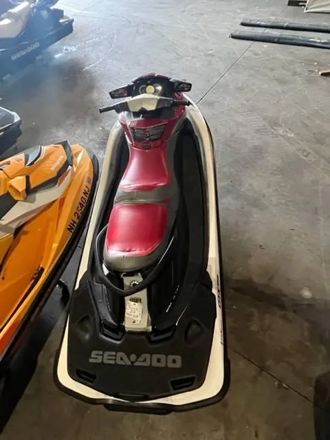 Slide: The Image of 2011 Sea-Doo GXT iS 215 jet ski with red seat in a garage. - 6