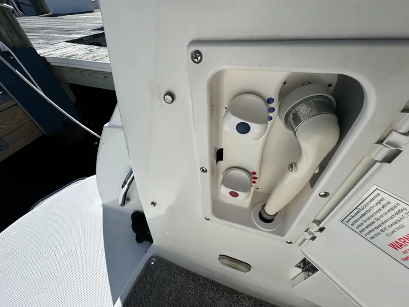 Slide: The Image of Bayliner 300 Ciera 2008 boat control panel with knobs and hose. - 13