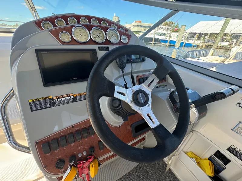 Slide: The Image of 2008 Bayliner 300 Ciera helm with steering wheel, gauges, and control panel. - 15