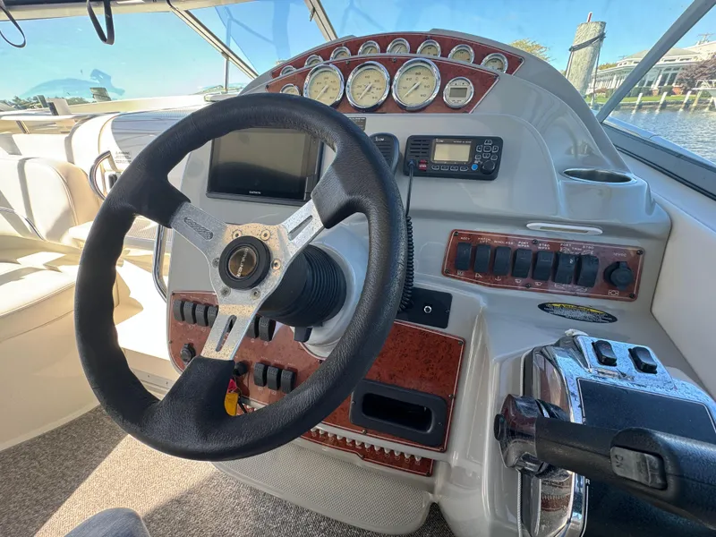Slide: The Image of 2008 Bayliner 300 Ciera helm with steering wheel, gauges, and control panel. - 16