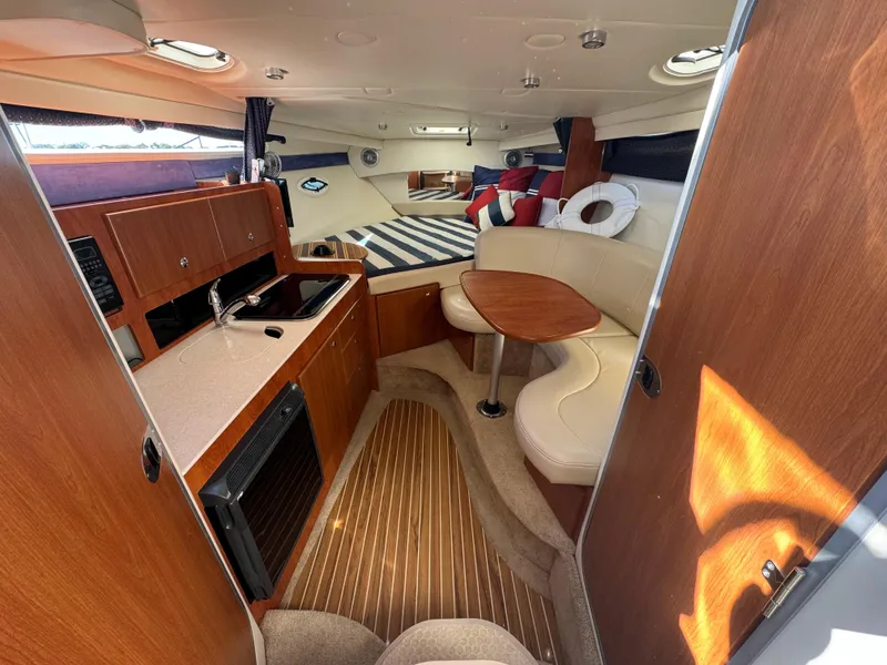 Slide: The Image of 2008 Bayliner 300 Ciera cabin interior with kitchenette and seating area. - 18