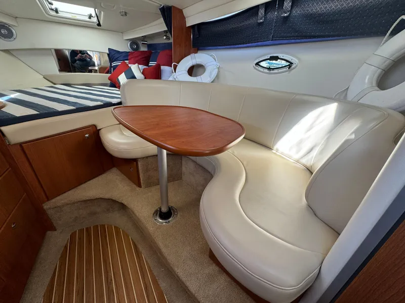 Slide: The Image of 2008 Bayliner 300 Ciera cabin with cozy seating and wooden table. - 19