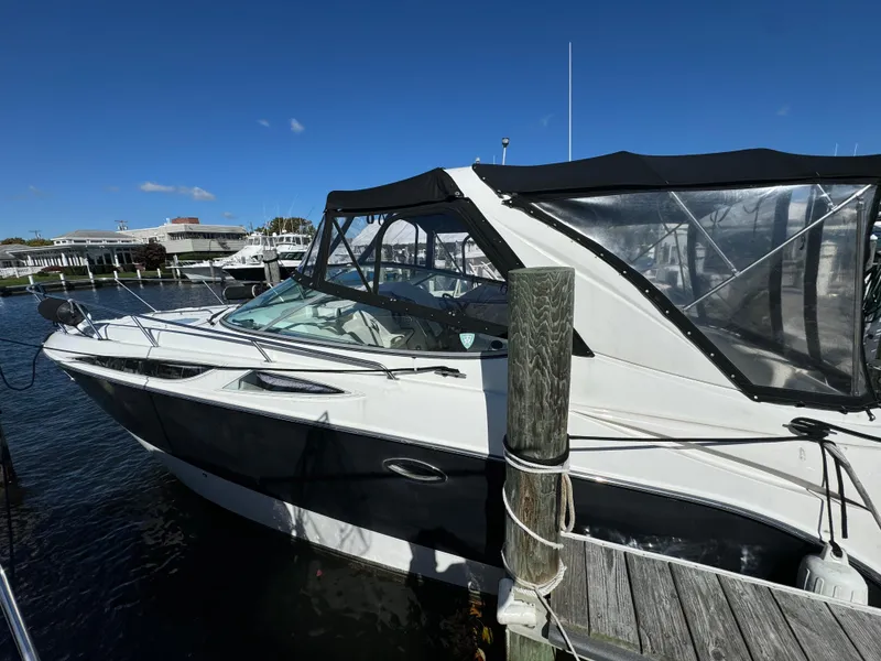 Slide: The Image of 2008 Bayliner 300 Ciera boat docked at marina under clear blue sky. - 2