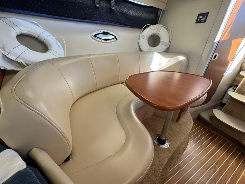 Slide: The Image of Interior of 2008 Bayliner 300 Ciera with beige seating and wooden table. - 20