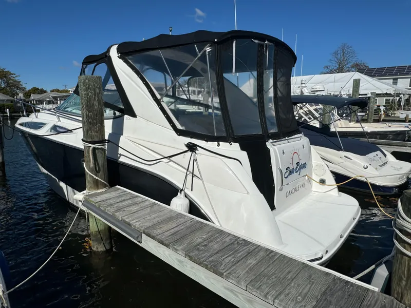 Slide: The Image of 2008 Bayliner 300 Ciera docked at marina, featuring sleek design and enclosed cockpit. - 4