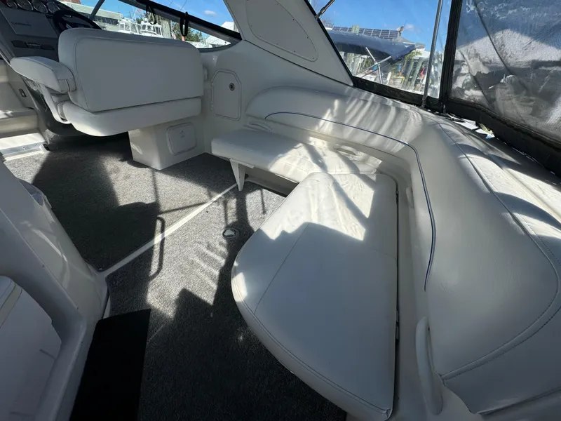 Slide: The Image of Interior of 2008 Bayliner 300 Ciera boat with white seating and carpeted floor. - 6
