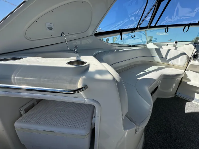 Slide: The Image of 2008 Bayliner 300 Ciera interior with seating and sink, featuring sleek design and ample sunlight. - 7