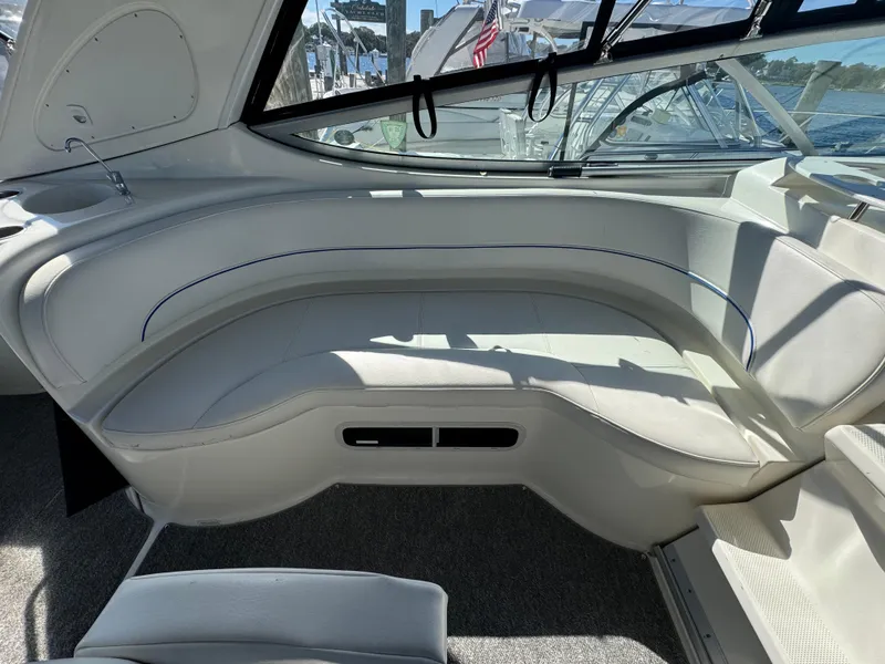 Slide: The Image of 2008 Bayliner 300 Ciera interior with white seating and windows, docked at marina. - 8