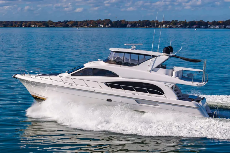 Slide: The Image of 2007 Hatteras 64 Motor Yacht cruising on a calm blue lake. - 1