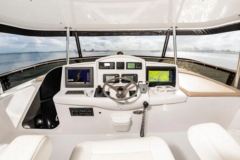 Slide: The Image of Helm of 2007 Hatteras 64 Motor Yacht with navigation screens and steering wheel. - 10