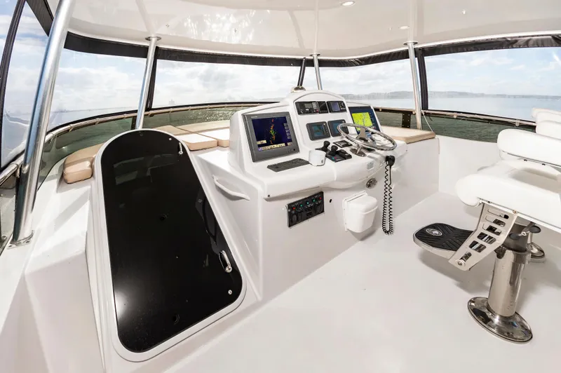 Slide: The Image of 2007 Hatteras 64 Motor Yacht helm with navigation equipment and ocean view. - 11
