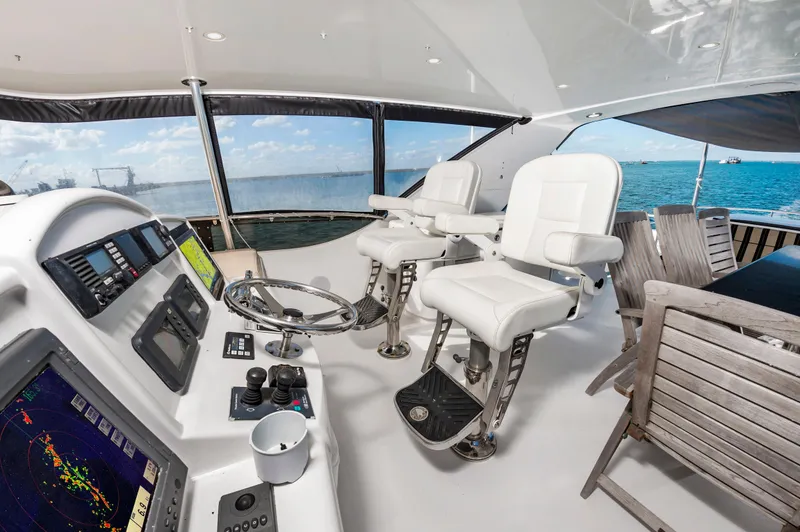 Slide: The Image of 2007 Hatteras 64 Motor Yacht helm with ocean view, featuring navigation equipment and seating. - 12