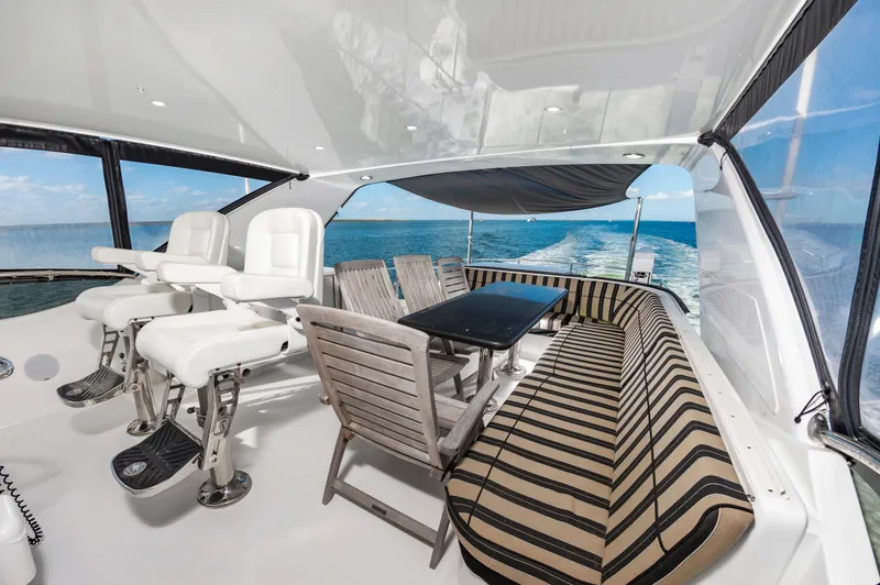 Slide: The Image of Luxurious 2007 Hatteras 64 Motor Yacht interior with seating and ocean view. - 13