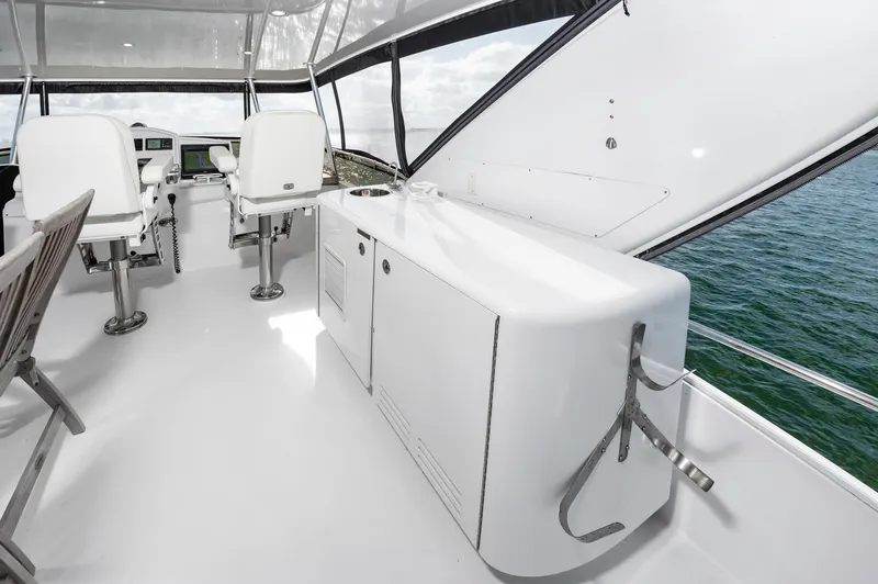 Slide: The Image of 2007 Hatteras 64 Motor Yacht helm with white seating and ocean view. - 15