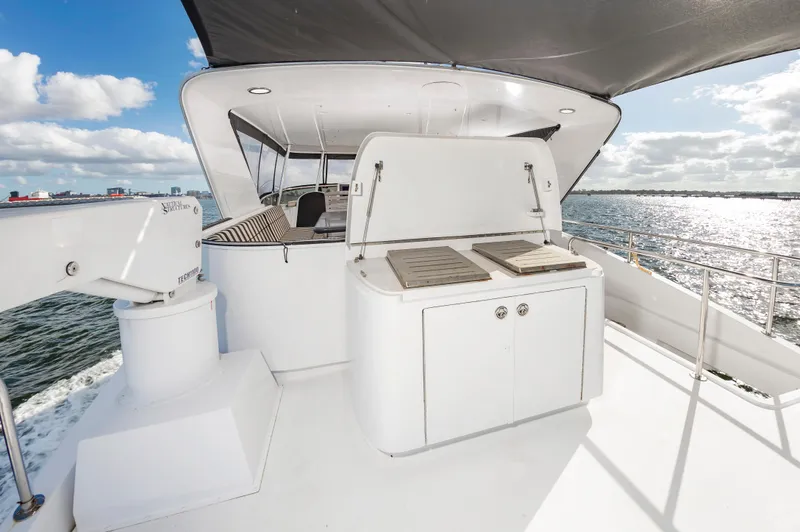 Slide: The Image of 2007 Hatteras 64 Motor Yacht deck with grill, ocean view, and seating area. - 18