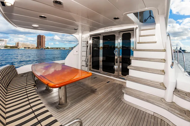 Slide: The Image of 2007 Hatteras 64 Motor Yacht deck with elegant seating and ocean view. - 22