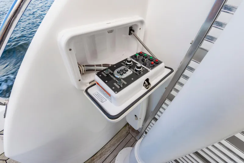 Slide: The Image of Control panel on 2007 Hatteras 64 Motor Yacht, featuring various switches and dials. - 23