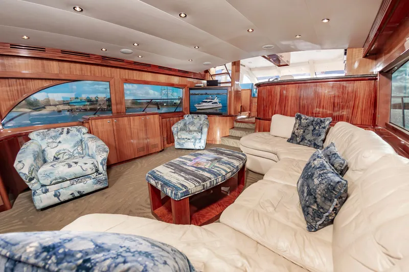 Slide: The Image of Luxurious interior of 2007 Hatteras 64 Motor Yacht with plush seating and elegant wood finishes. - 26