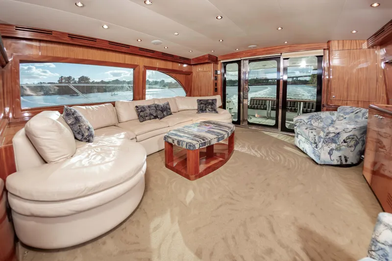 Slide: The Image of Luxurious interior of 2007 Hatteras 64 Motor Yacht with plush seating and scenic windows. - 27