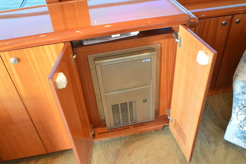 Slide: The Image of Open cabinet on 2007 Hatteras 64 Motor Yacht revealing built-in appliance. - 28
