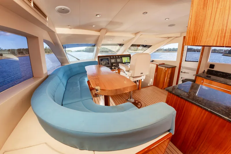 Slide: The Image of Luxurious 2007 Hatteras 64 Motor Yacht interior with elegant seating and navigation area. - 31
