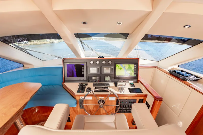 Slide: The Image of Interior helm of 2007 Hatteras 64 Motor Yacht with navigation screens and leather seating. - 33