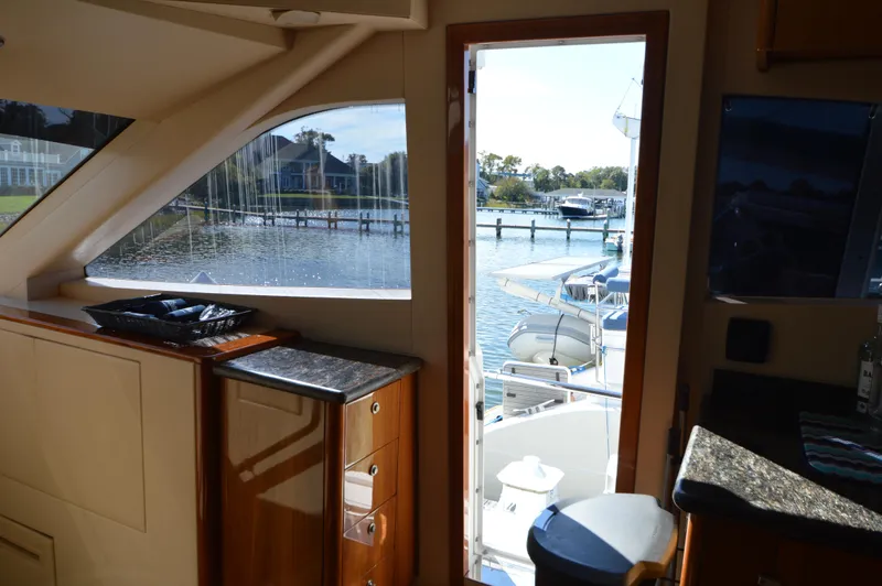 Slide: The Image of Interior view of 2007 Hatteras 64 Motor Yacht with open door to marina. - 35
