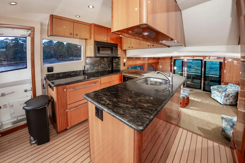 Slide: The Image of Luxurious interior of 2007 Hatteras 64 Motor Yacht with modern kitchen and ocean view. - 36