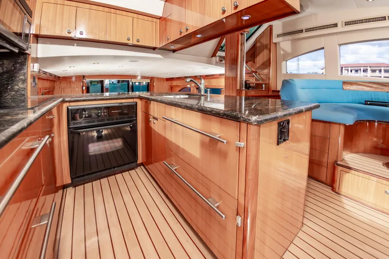 Slide: The Image of Luxurious kitchen interior of 2007 Hatteras 64 Motor Yacht with wood cabinetry and granite countertops. - 39